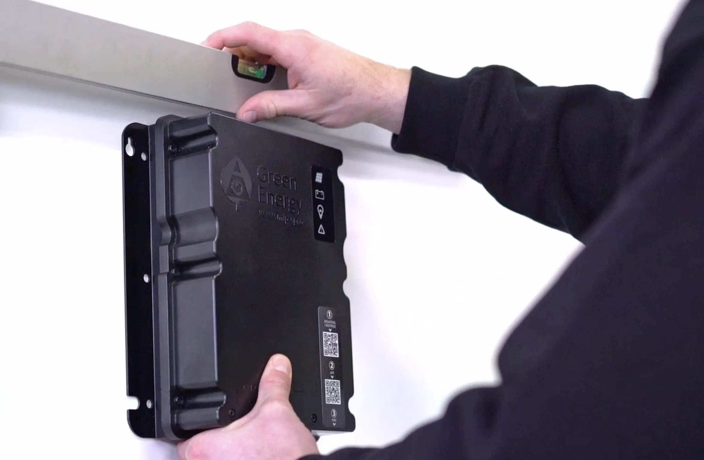 Man mounting a Green Energy Charge Controller